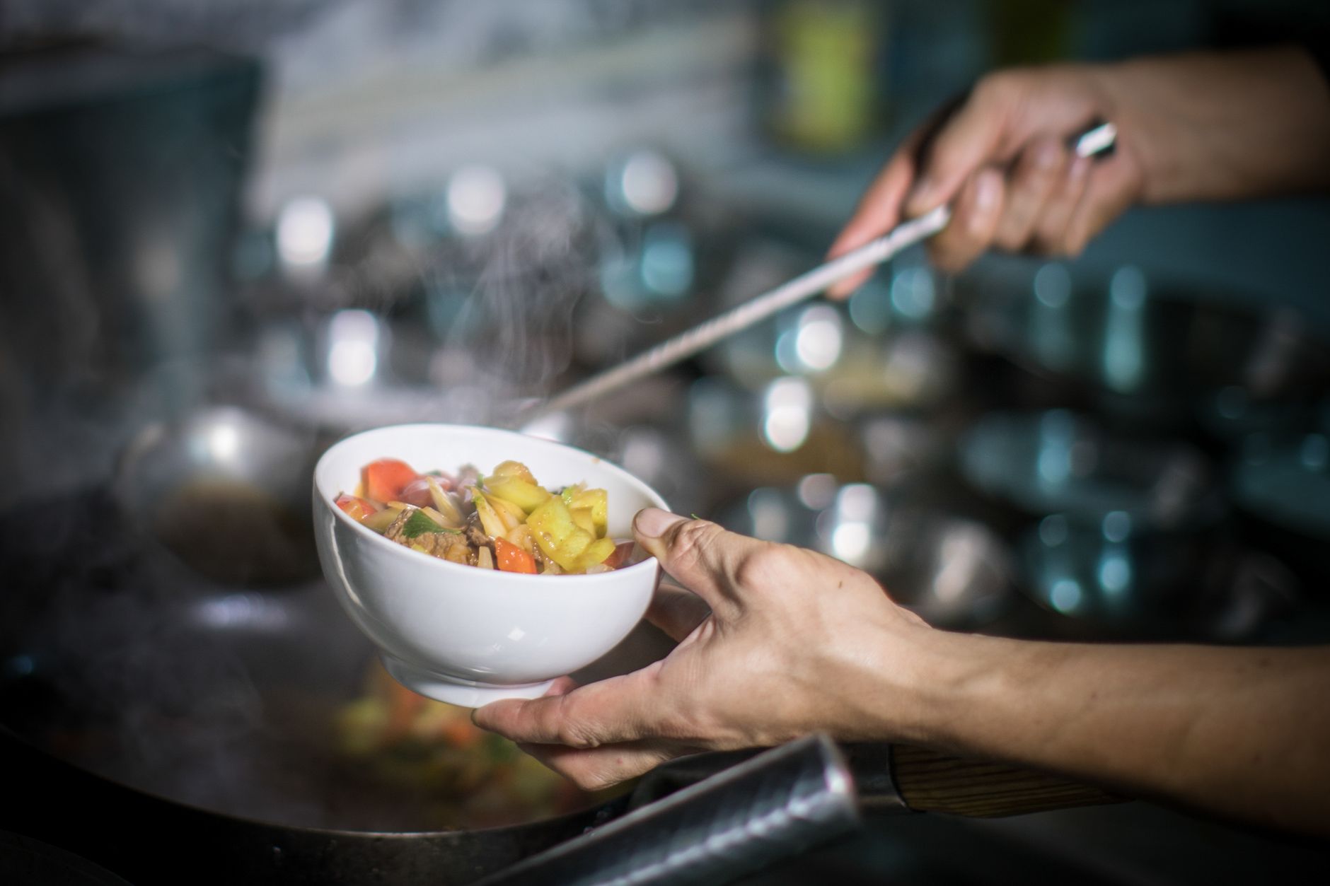 Chef cooking vegetables in a restaurant kitchen